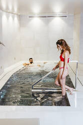 Man and woman enjoying the whirlpool in a spa - LJF00396