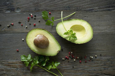 Halved avocado, parsley and pepper seen from above - ASF06441