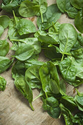 Fresh spinach leaves on wooden table seen from above - ASF06444