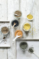 Assorted lentils on wooden table seen from above - ASF06447