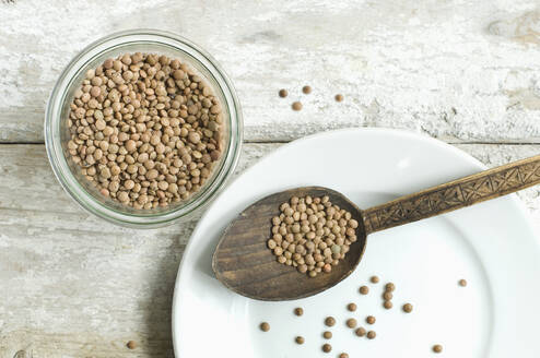 Jar of Mountain lentils on wooden table seen from above - ASF06453