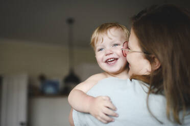 Portrait of little boy on his mother's arms at home - EYAF00301