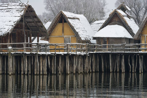 Deutschland, Baden-Württemberg, Schneebedeckte Stelzenhäuser am Bodensee, lizenzfreies Stockfoto