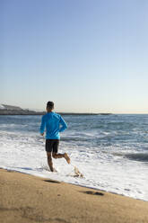 Man jogging on the beach - MAUF02653