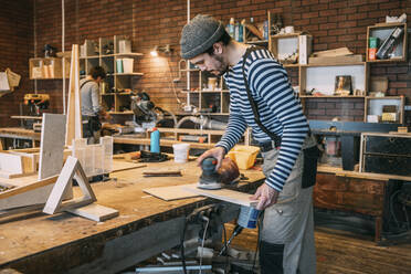 Carpenters at work, grinding wood - VPIF01340