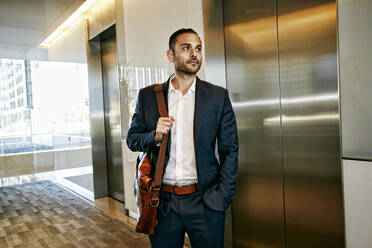 Caucasian businessman waiting for office elevator - BLEF09607