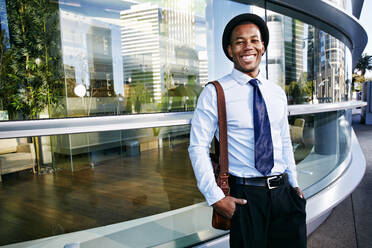 Black businessman smiling outside office building - BLEF09609