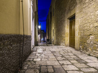 Illuminated empty alley amidst buildings in old town at night - AMF07177