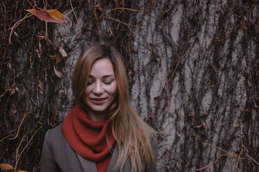 Portrait of smiling woman with eyes closed in autumn - OGF00052