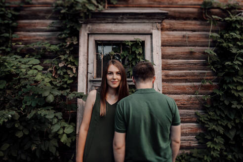 Couple standing in front of frame house - OGF00058