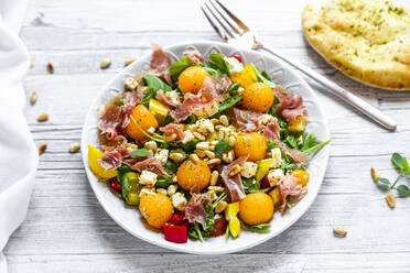 High angle view of healthy salad in plate on wooden table - SARF04341