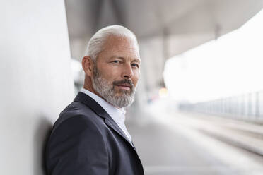 Portrait of mature businessman at the station platform - DIGF07433