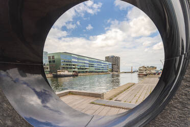 Malmo University by canal against sky seen from sculpture - TAM01782