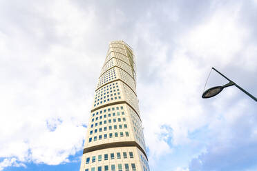 Low angle view of Turning torso against cloudy sky - TAMF01793