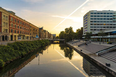 Residential buildings by Sodra Forstadskanalen in city against sky during sunset - TAMF01810