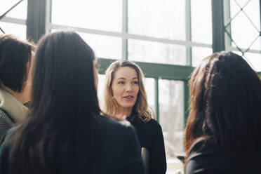 Mature businesswoman discussing with colleagues in conference meeting - MASF12978