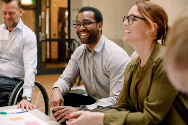 Business professionals smiling during sales meeting in office - MASF13029