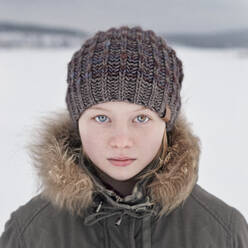 Caucasian teenage girl wearing beanie hat in snow - BLEF09753