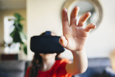 Mixed race girl using virtual reality goggles - BLEF09831