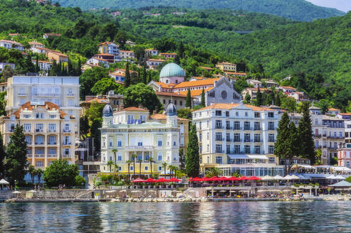 Residential buildings in Opatija town by Adriatic sea against mountain - THAF02540