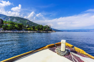 Cropped image of boat moving on Adriatic sea by mountain against sky - THAF02542