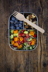 Directly above view of fresh meal in lunch box with fork on wooden table - LVF08171