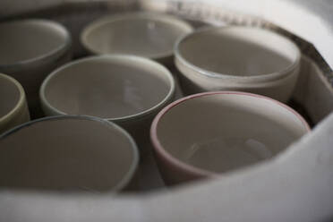 Clay bowls in a kiln, close-up - ABZF02392