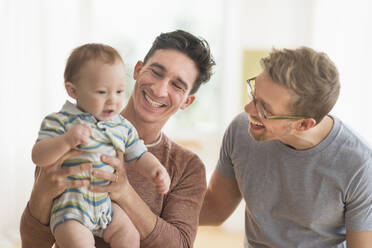 Caucasian gay fathers holding baby - BLEF10075
