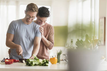 Caucasian gay couple cooking in kitchen - BLEF10077