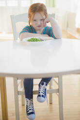 Caucasian girl pouting at plate of vegetables - BLEF10104