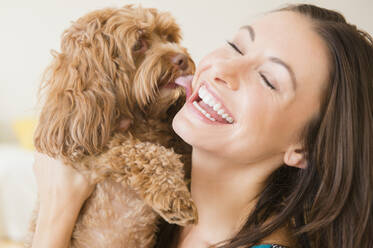 Caucasian woman playing with pet dog - BLEF10147