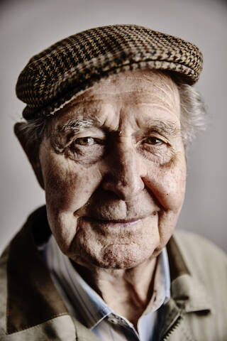 Portrait of smiling senior man wearing cap stock photo