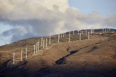 Windturbinen auf einem Hügel gegen den bewölkten Himmel bei Sonnenuntergang - CVF01307