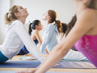 Women practicing yoga in class - BLEF10216