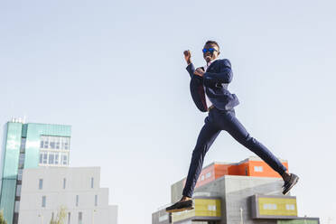 Young businessman jumping mid-air - LJF00465