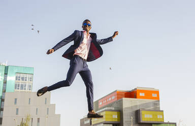 Young businessman jumping mid-air - LJF00466