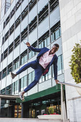 Young businessman jumping mid-air - LJF00482