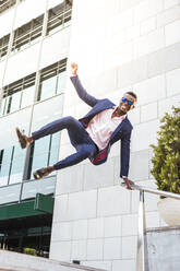 Young businessman jumping mid-air - LJF00484