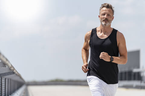 Sporty man jogging stock photo