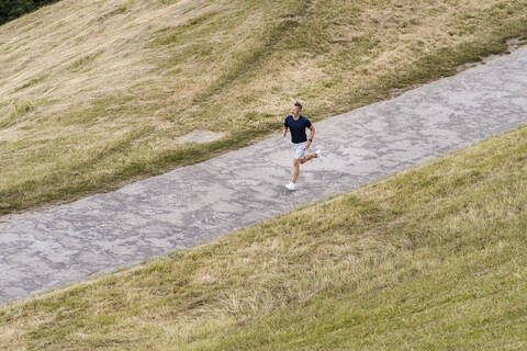 Sporty man jogging in a park stock photo