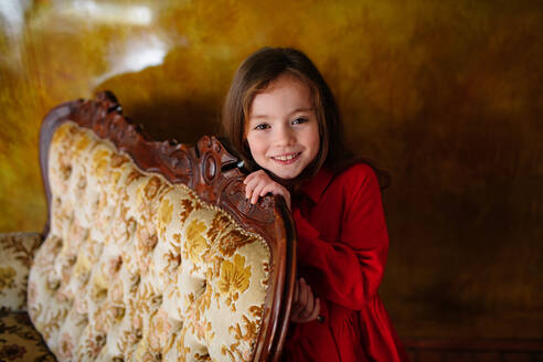 Portrait of smiling little girl wearing red dress - OGF00076