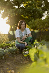 Woman working in her vegetable garden - MAUF02682