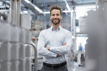 Portrait of a confident businessman in a modern factory - DIGF07568