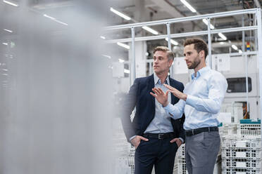 Two businessmen talking in a modern factory - DIGF07582