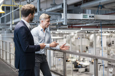 Two businessmen talking in a modern factory - DIGF07593