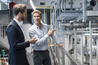 Two businessmen talking in a modern factory - DIGF07594