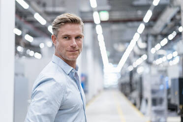 Portrait of a confident businessman in a modern factory - DIGF07603