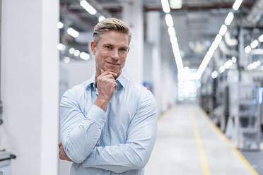 Portrait of a confident businessman in a modern factory - DIGF07604