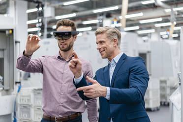 Two businessmen with AR glasses in a modern factory - DIGF07626