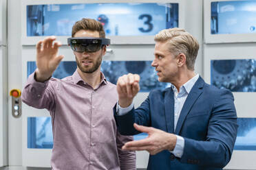 Two businessmen with AR glasses in a modern factory - DIGF07628